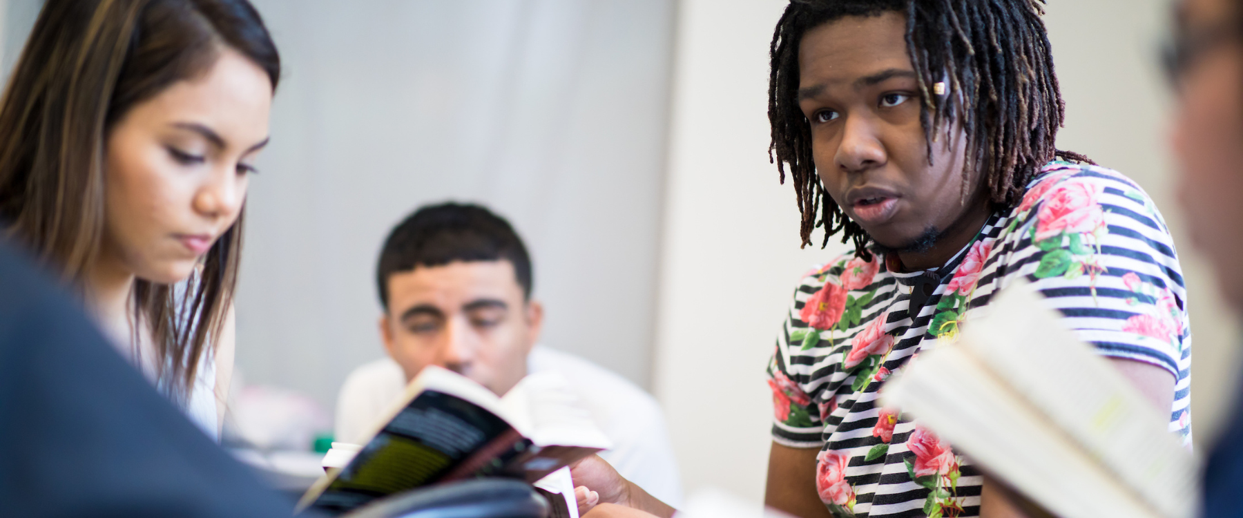 Loyola Golden Apple scholars studying at desk with books